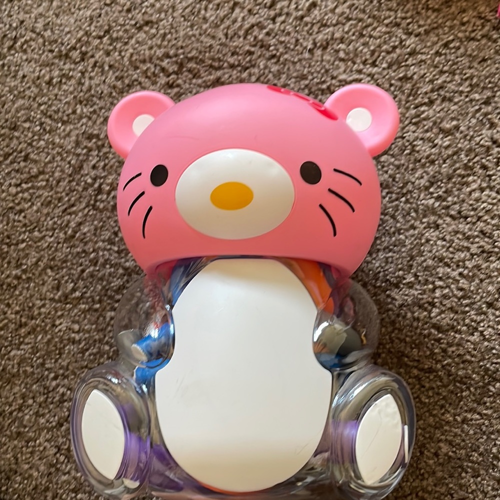 Hello kitty, coin bank with hair curlers inside